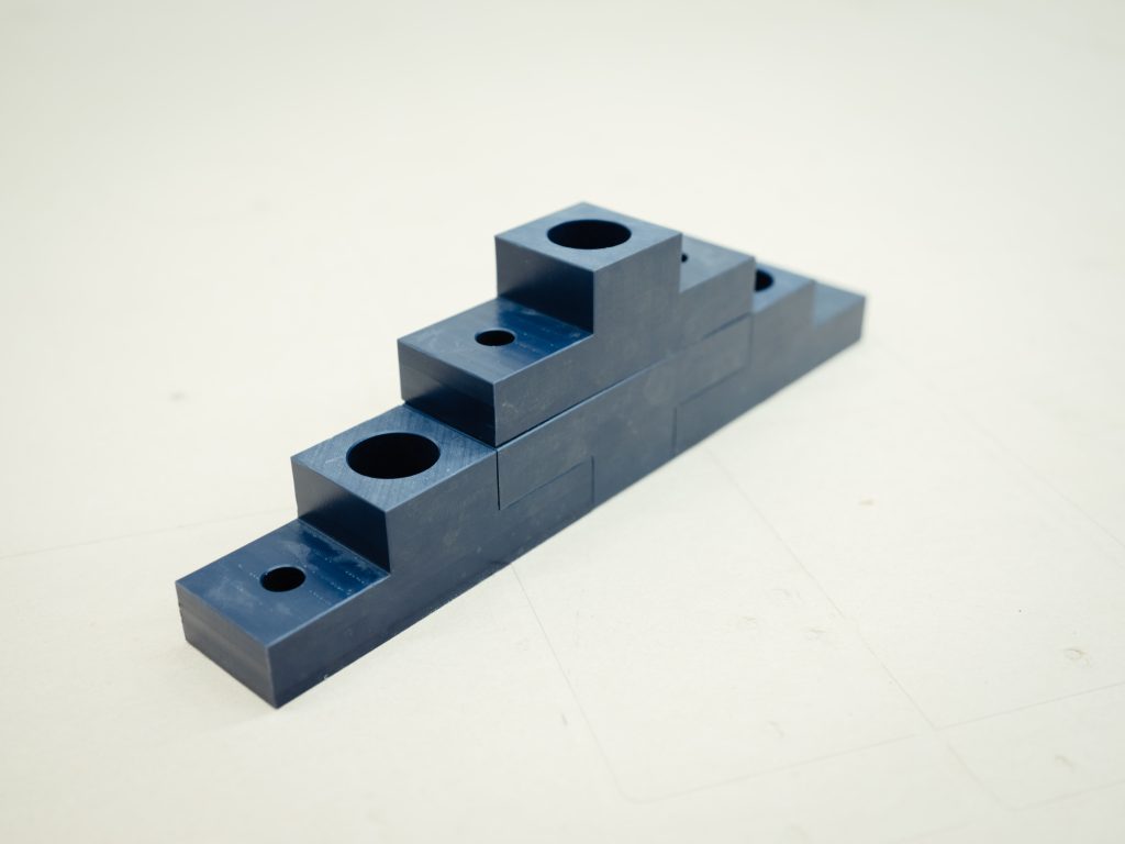 A stack of UHMW parts arranged in a pyramid.
